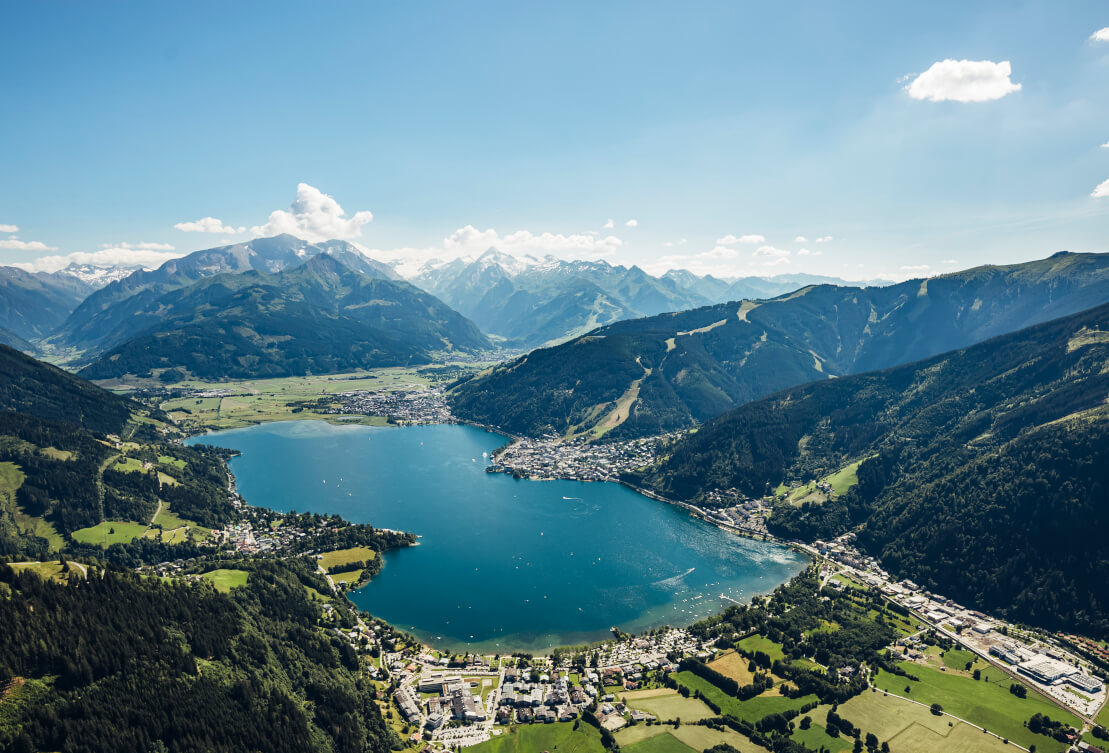 Zell am See lake panorama with alpine mountains clear blue water summer Austria
