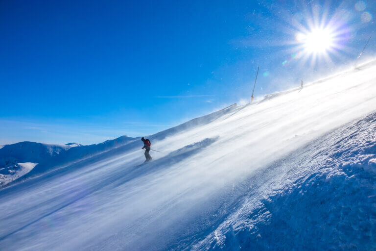 Skier on a sunny alpine slope