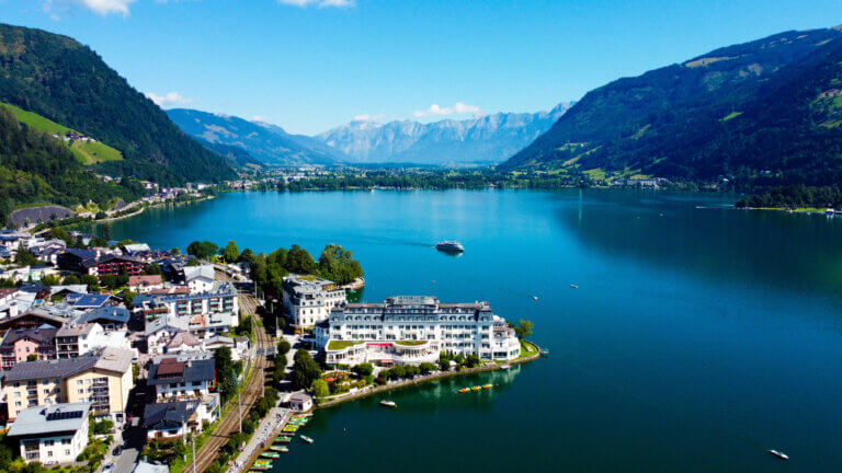 Zell am See lake panorama with alpine mountains clear blue water summer Austria