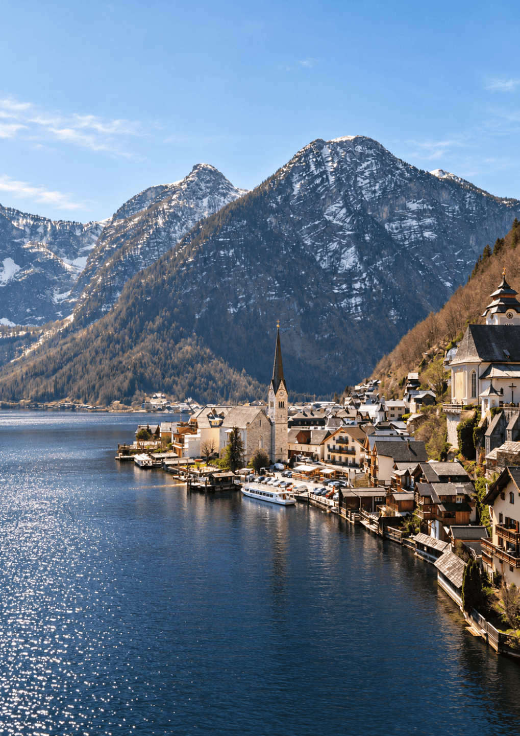 Alpine village by a calm mountain lake in winter