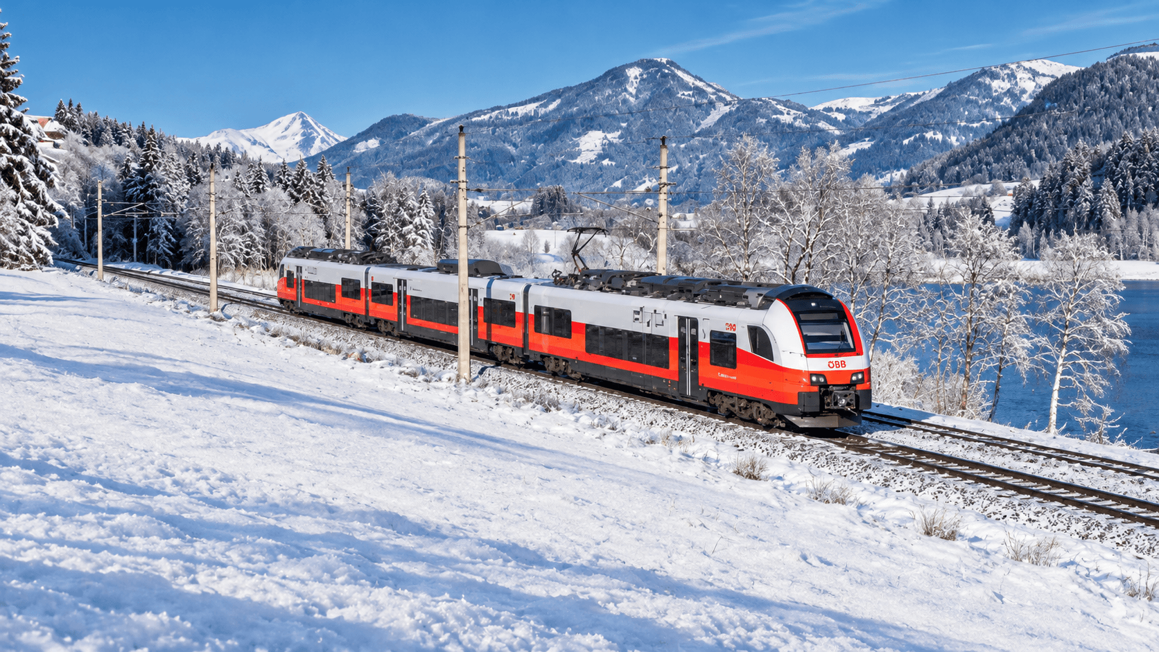 A winter train running along a snowy Alpine lake