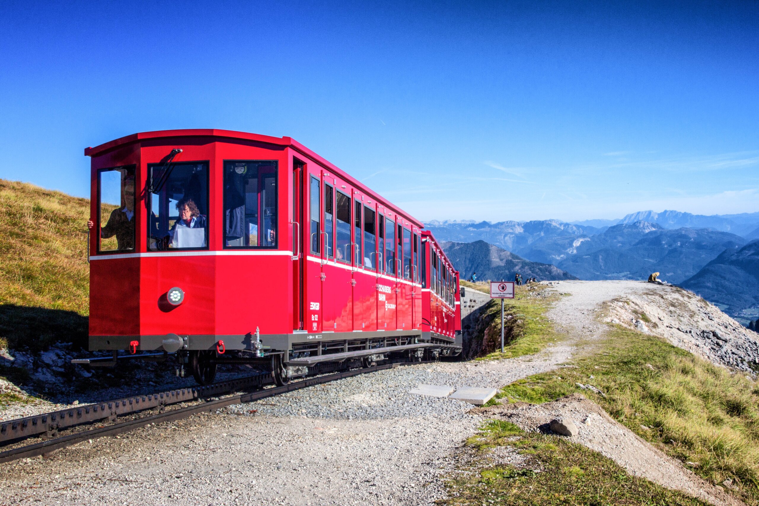 Red Schafbergbahn cog railway above the Wolfgangsee