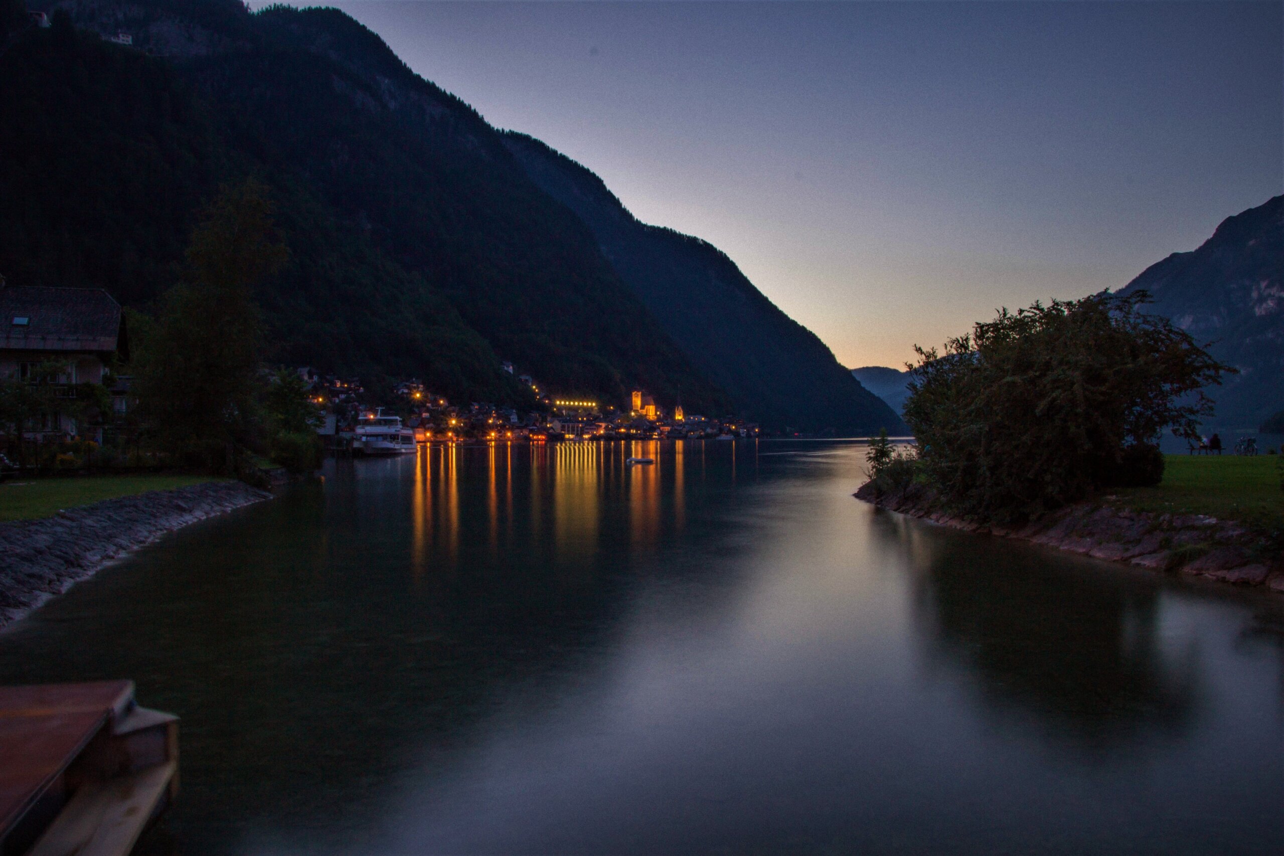 Hallstatt at night with the church reflected in the lake
