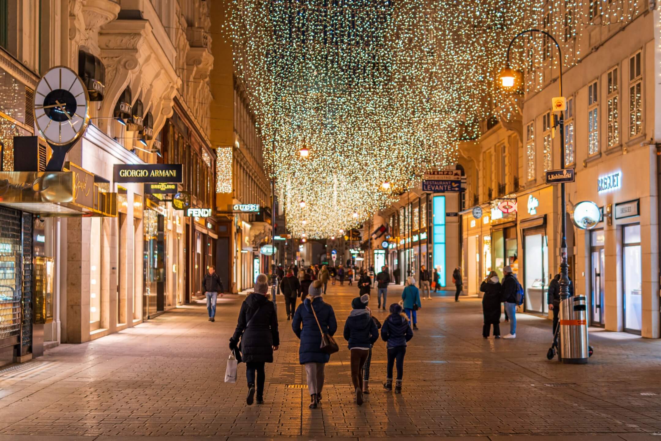 A Christmas market glowing with lights on a winter evening